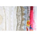 A quantity of antique and vintage domestic textiles including tablecloths, doilies, linen and