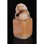 A Chinese carved soapstone seal, its top carved as a dragon, 52 mm
