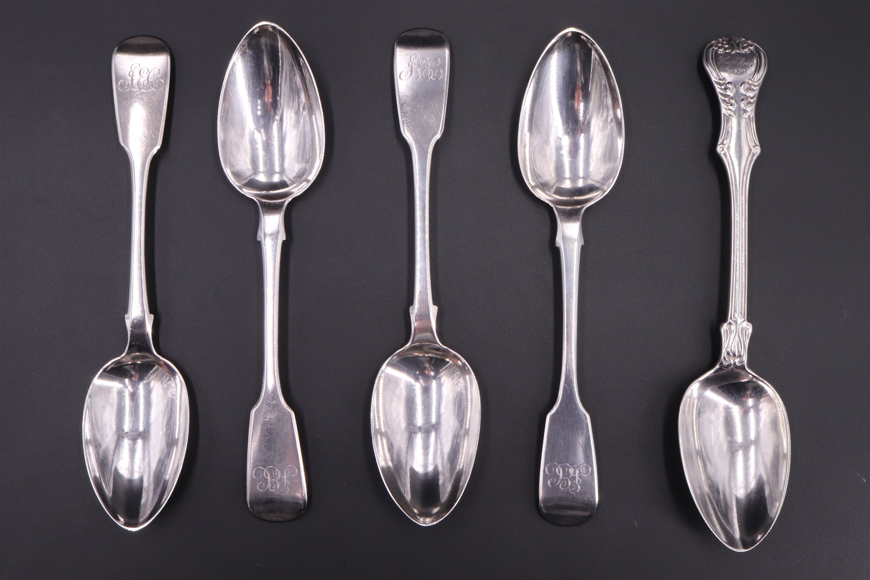 A set of four William IV Fiddle pattern silver table spoons, together with an Hourglass pattern