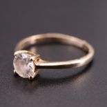 A modern white sapphire 9 ct gold solitaire ring, having a 5.5 mm brilliant claw set on a gallery