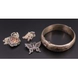 An early 1960s engraved silver hinged bangle together with a marcassite butterfly brooch, a heart-