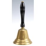 A late 20th Century brass hand bell having an ebonised and turned wood handle, 24 cm