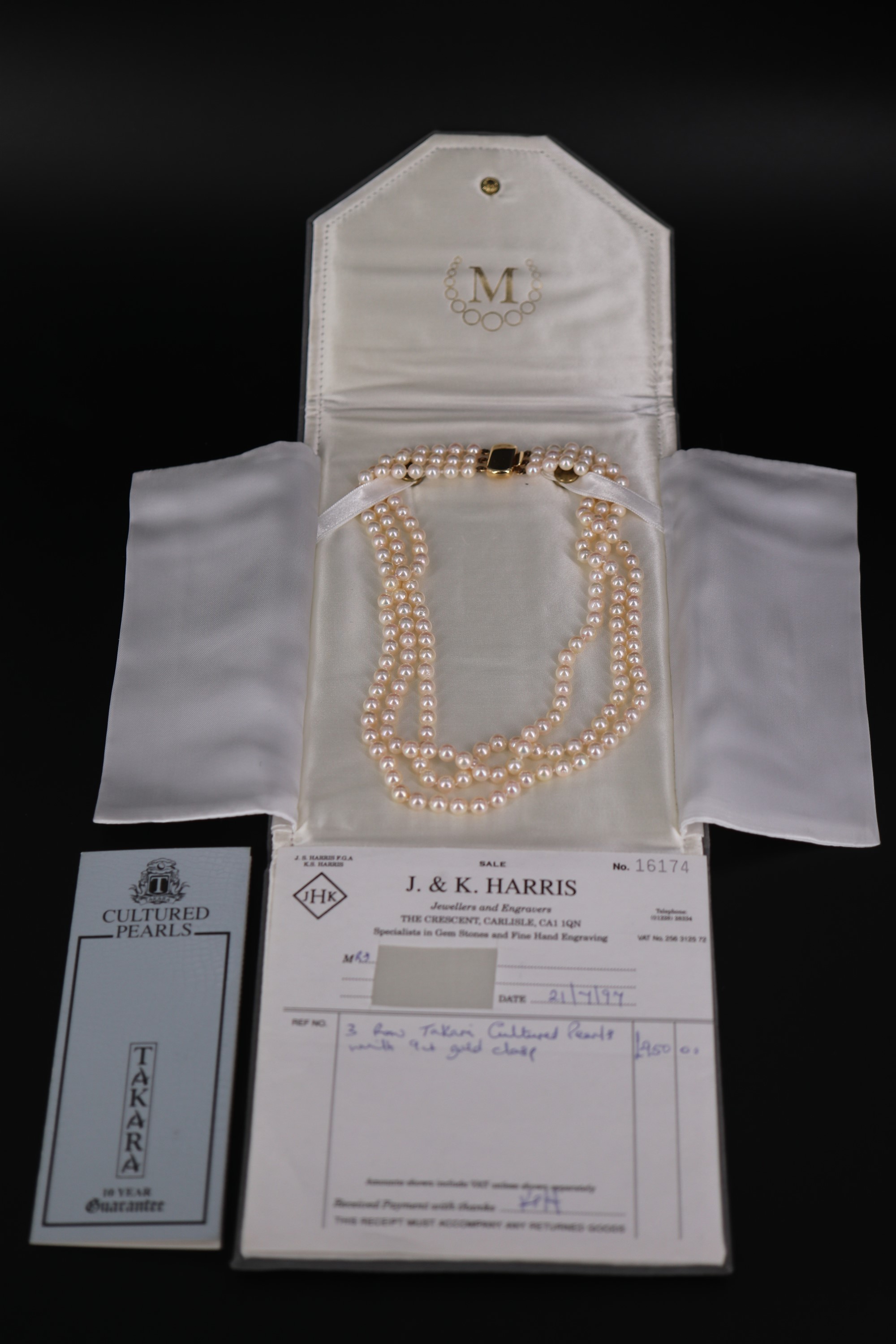 A three-strand necklace of uniform Takara cultured pearls, having an 18 ct gold clasp set with a - Image 3 of 4