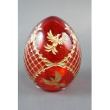 A Russian Motiven hand cut and parcel gilt ruby glass egg, 10 cm
