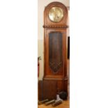 An oak long case clock, having a three-train weight-driven movement and brass face, circa 1930s, 202