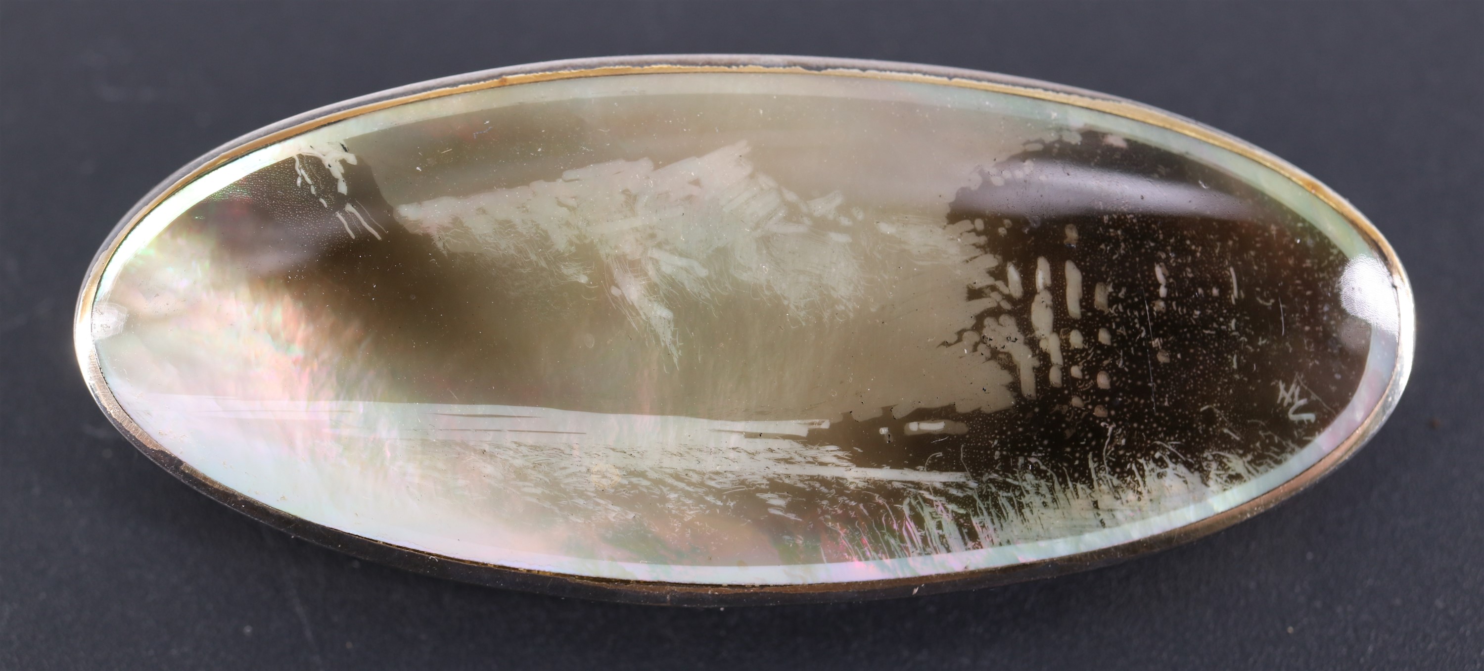 A silver-mounted candlesmoke lakeview on mother-of-pearl brooch by Maurice William Crawshaw, with
