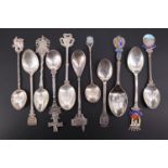 Seven enamelled and other souvenir silver spoons together with four similar white metal spoons,