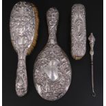 A late Victorian Walker & Hall silver-backed brush and a hand mirror, embossed decorated in
