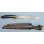 An early 20th Century Asian knife, having a carved hardwood grip and kukri-like blade bearing struck