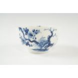 An 18th Century underglaze blue Worcester tea bowl in the Prunus Root pattern, the base having an