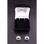 A pair of emerald, white stone and 18 ct yellow metal cluster earrings, each centred by an oval