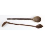 An antique ethnic carved wooden double-ended ladle together with a spoon, former 44 cm