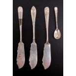 Three George V silver butter knives and a condiment spoon, including a pair of knives having shell