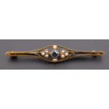 An early 20th Century blue topaz and seed pearl bar brooch, comprising a central round cut stone