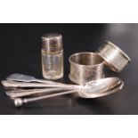 Two silver napkins rings, a silver-mounted scent bottle and four various silver spoons