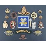 A small group of cap and other badges including a Royal Ordnance Factory printed badge, (some a/f)