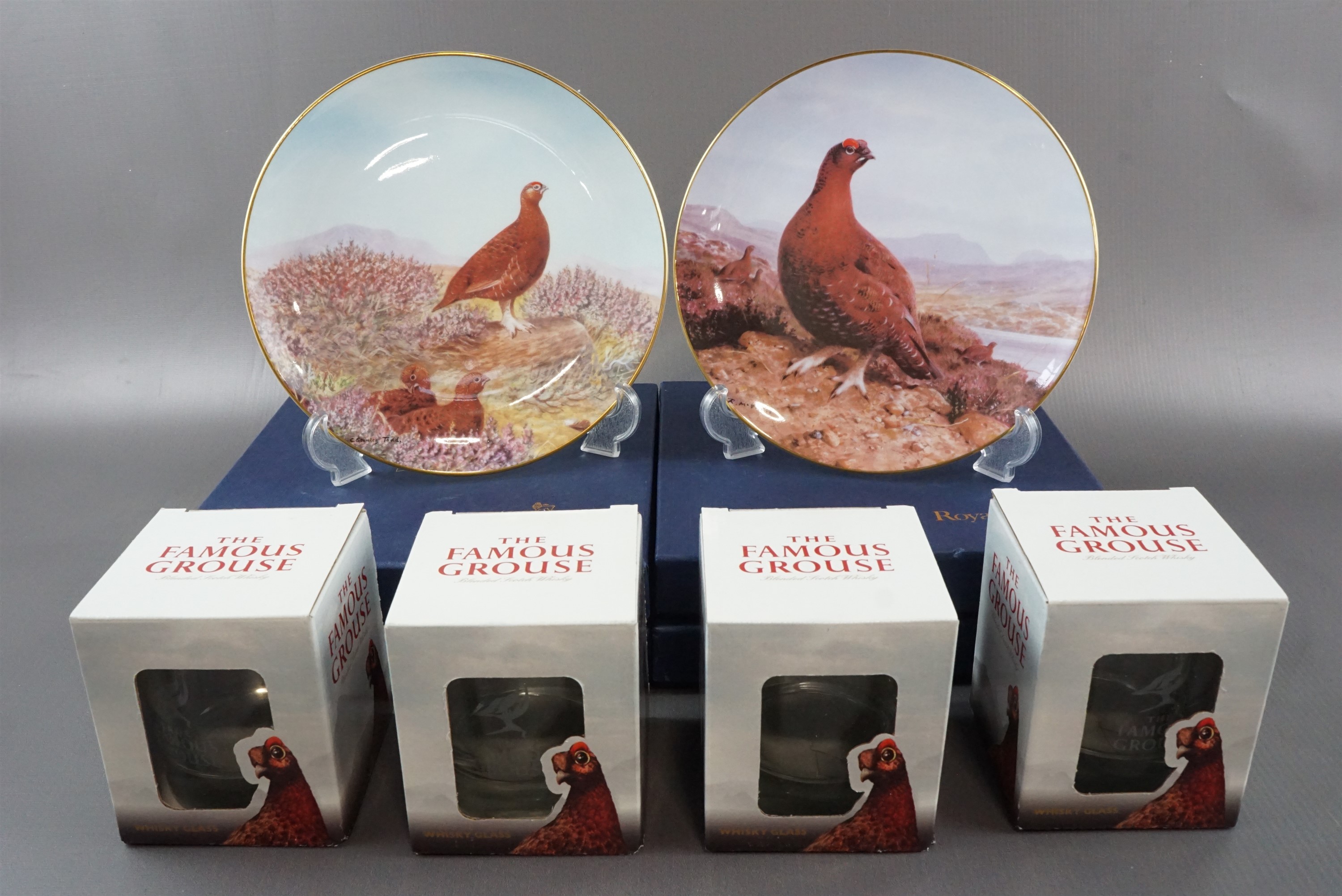Four boxed Royal Doulton The Famous Grouse Club plates, comprising "Summer in the Highlands", "At