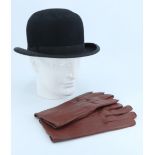 A vintage bowler hat and a pair of leather gloves