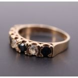 A sapphire and cubic zirconia half hoop eternity ring, the stones set on 9 ct gold, N/O, 2.5 g