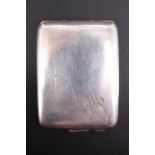 A 1920s silver matchbook case, of cushion form with engraved monogram, its interior gilt, William