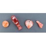 A miniature carnelian seal, of baluster form having a vacant matrix, together with a hardstone