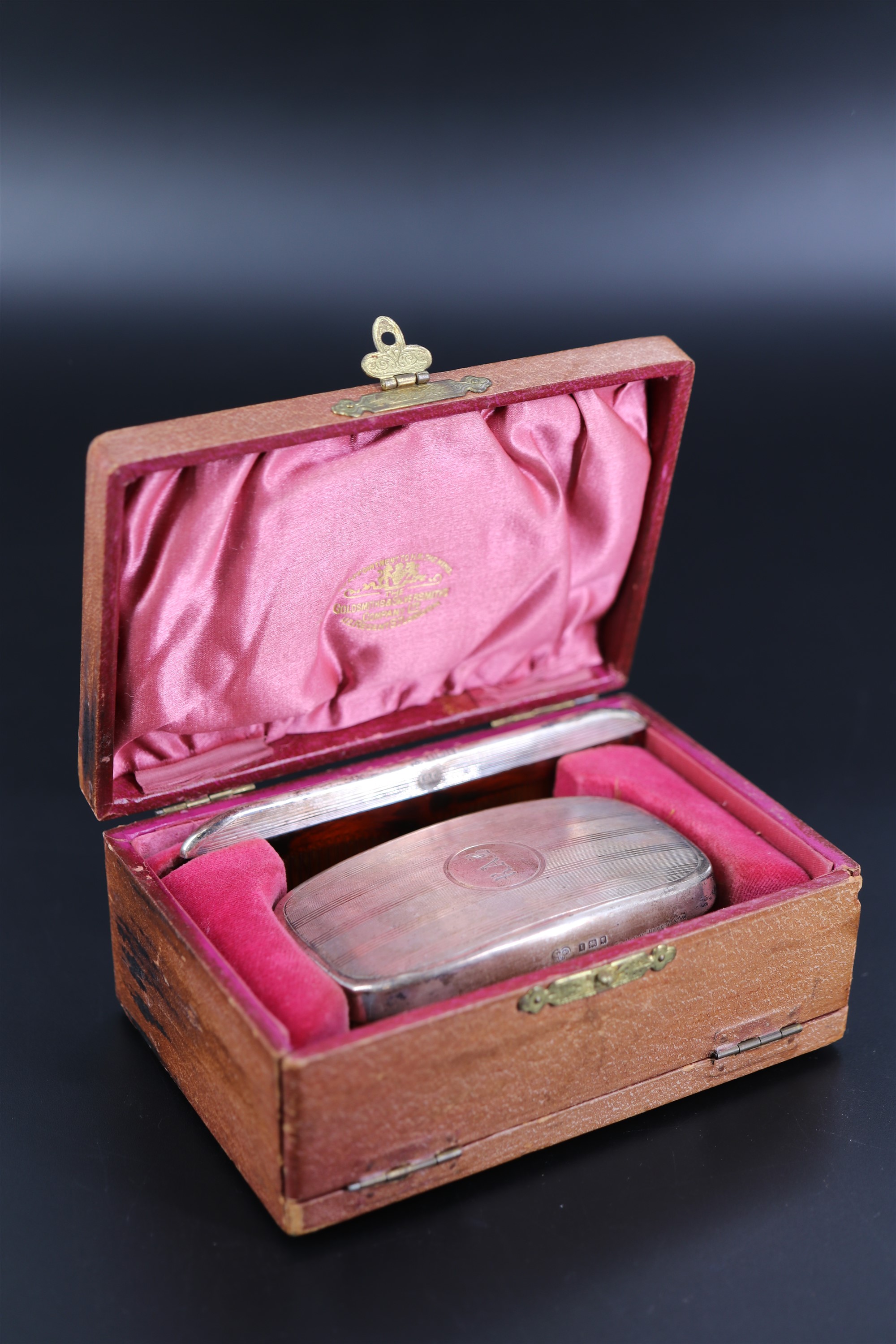 A 1920s silver mounted brush in The Goldsmiths & Silversmiths Company Ltd travel case, the brush