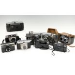A group of vintage cameras, including a Halina AI and a Paulette, a Voigtlander Bessa I, etc