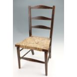 A child's rush-seated ladder-back chair, 66 cm