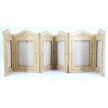 A hide bound folding photograph frame, having six displays and bearing baroque influenced