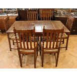 A George V oak dining suite comprising six chairs and a draw-leaf dining table, circa 1920s, table