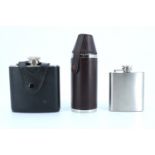 A stainless steel flask and toddy cup set together with two similar hip flasks, tallest 15 cm