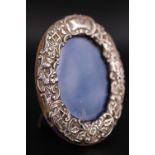 A late Victorian embossed silver-faced diminutive oval photograph frame, W & M Dodge (William