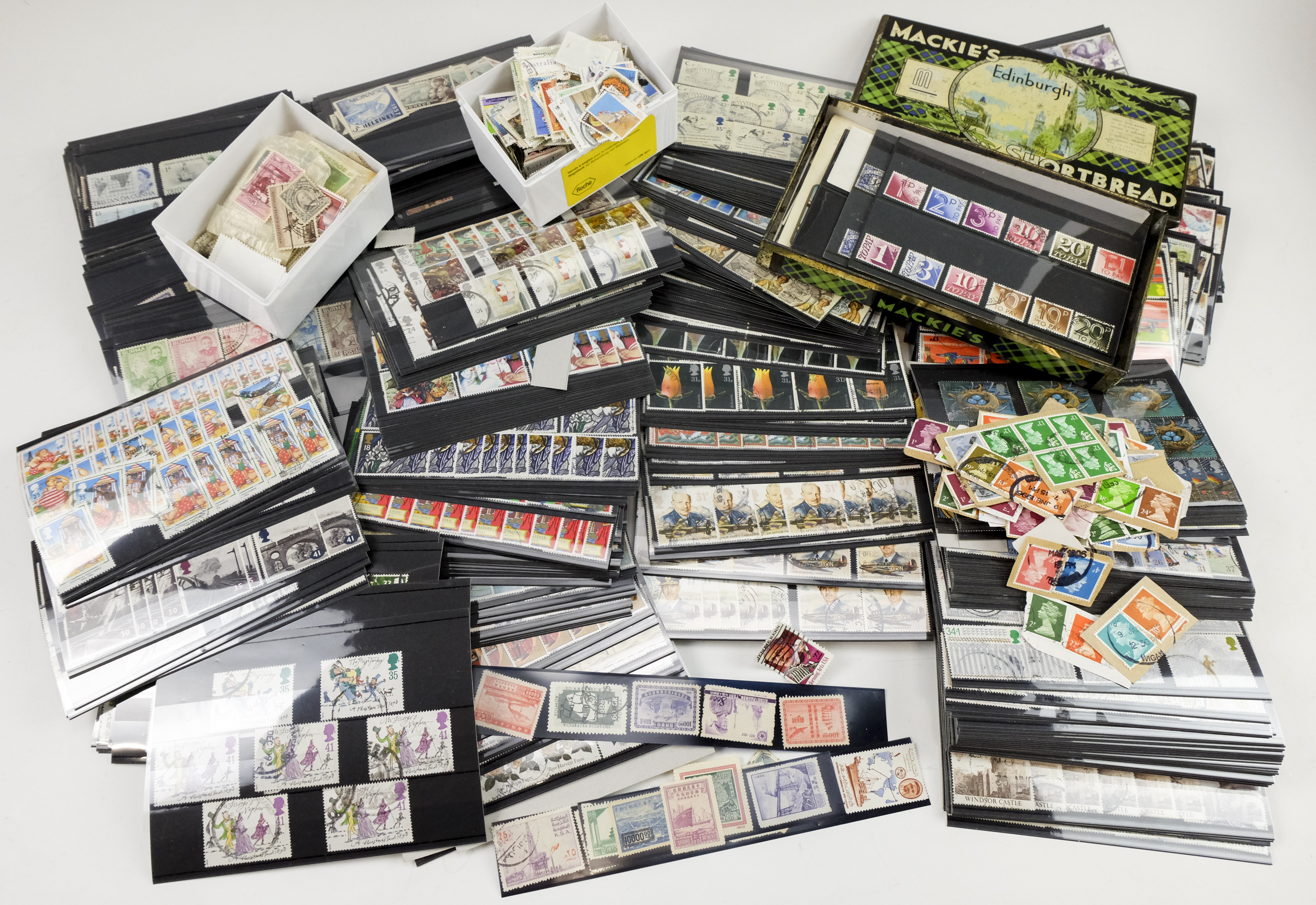 A large group of stock cards containing an extensive collection of GB and world stamps, including