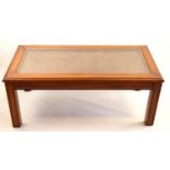 A contemporary glass- and cane-topped coffee table, 100 cm x 52 cm x 42 cm