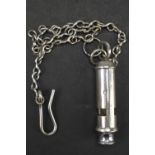 A 1944 British military broad arrow marked Beaufort type whistle together with chain