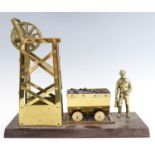 A 1980s brass model of a pit head mining scene, 33 cm x 12 cm x 28 cm