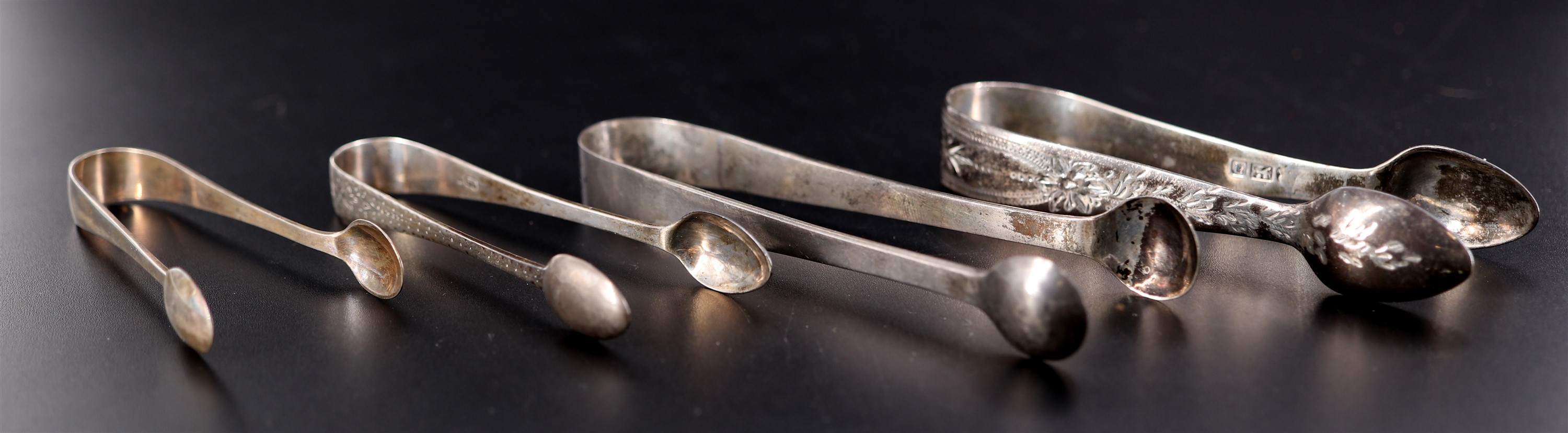 Four various Victorian and later silver sugar tongs, 78 g