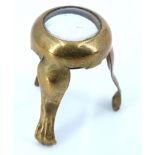 A small early 19th Century brass tripod magnifying glass, having cabriole-type legs with claw