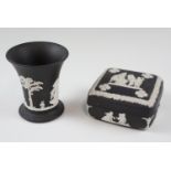 A Wedgwood black Jasperware trumpet vase and a lidded box, vase 9.5 cm