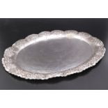 A fine early 20th Century hand-worked white metal oval salver, of cusped oval form with lobed of
