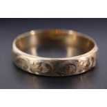 A silver gilt hinged bangle, of shallow D-section and foliate scroll engraved, Birmingham, 1976, 6