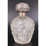 An Edwardian silver-mounted cut glass scent bottle, of shouldered form, having a ground-in stopper