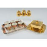 A Carlisle Ware egg cup set by Burgess Bros together with a Royal Winton Golden Age condiment set,