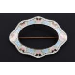 A late 19th / early 20th Century American basse taille enamelled white metal shaped-oval brooch by