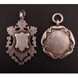 Two early 20th Century silver watch fob medallions, one being pierced with escutcheons front and