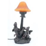 A Widdop Bingham & Co Ltd cold cast figural table lamp, modeled as two fairies beneath a