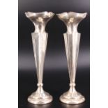 A pair of George V trumpet form silver vases, of fluted tapering square form on weighted pedestal
