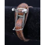 An early 20th Century watch strap with spring clip to carry a fob watch