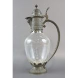 A late 19th / early 20th Century shouldered oviform glass wine ewer, pewter / Britannia metal