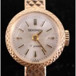 A 1960s Sekonda 9 ct gold wristlet watch, having a 17 jewel movement, a silver dial with baton